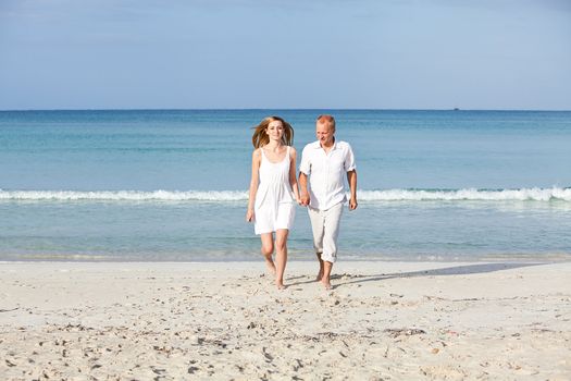 happy young couple in love having fun on the beach blue sky and sunshine 