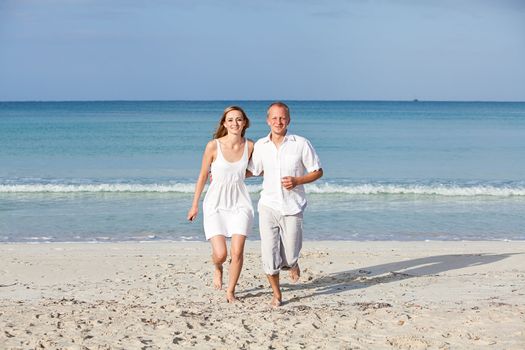 happy young couple in love having fun on the beach blue sky and sunshine 