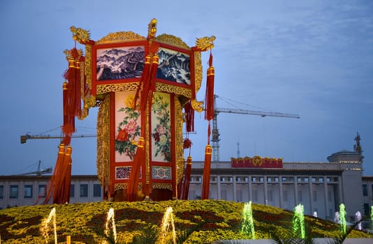 Large Chinese Lantern Decoration Tiananmen Square, Beijing, China.  Decoration is for October 1st Holiday.  Back of the Lantern Decoration is the Chinese National Museum and building cranes