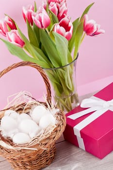 pink present with ribbon and colorful tulips festive easter decoration