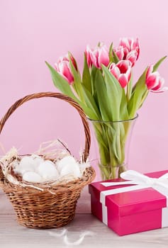 pink present with ribbon and colorful tulips festive easter decoration