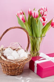 pink present with ribbon and colorful tulips festive easter decoration