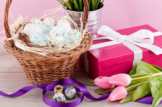 pink present with ribbon and colorful tulips festive easter decoration