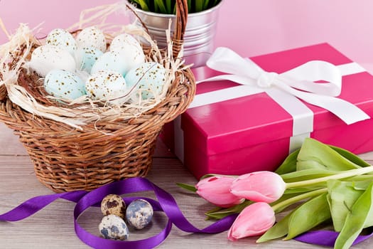 pink present with ribbon and colorful tulips festive easter decoration