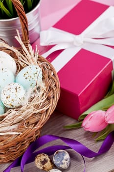 pink present with ribbon and colorful tulips festive easter decoration