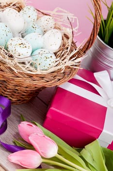 pink present with ribbon and colorful tulips festive easter decoration