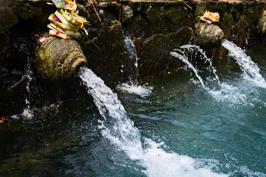 Holy sacred spring water in Puru Tirtha Empul Temple, Bali, Indonesia with purifying pools