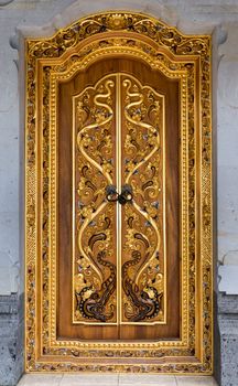 Balinese carving door in Tirta Empul temple, Bali, Indonesia. Selective focus on the centre.