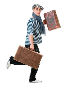 Hurry young male traveller with two old vintage suitcases isolated on white background