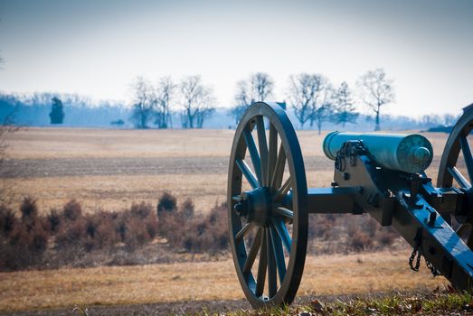 Photograph of a lone cannon pointed towards the Union line at Gettysburg.