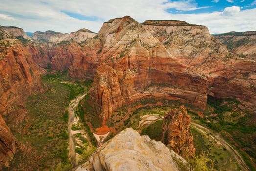 Photograph looking north along the Virgin River with the famous red road curving around the bends in the canyon walls at Zion National Park.