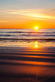 Photograph of the reflection and contouring created by the sun rising low over the horizon and reflecting in the sand.