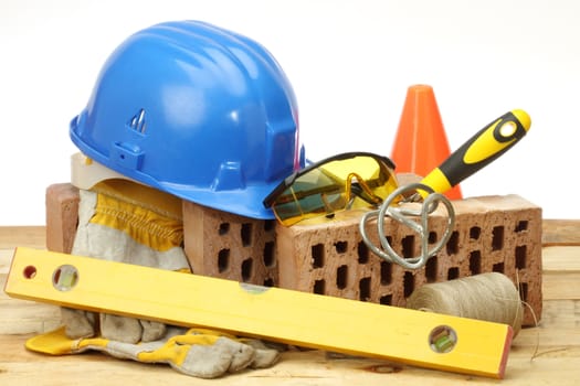 Bricks, trowel and helmet on work place