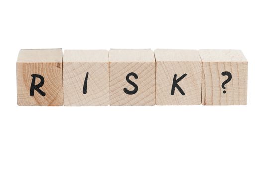 Risk with question mark written with wooden blocks.