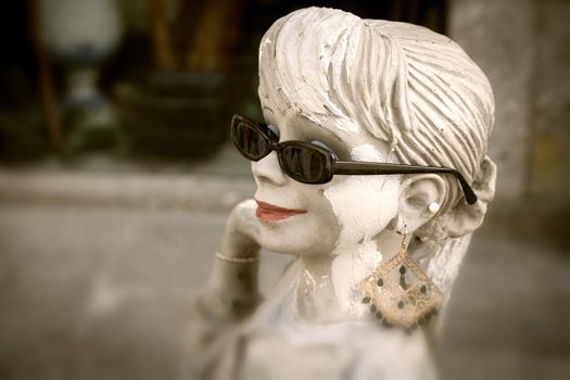 Old antique girl mannequin outside antique shop - Braga, Portugal.