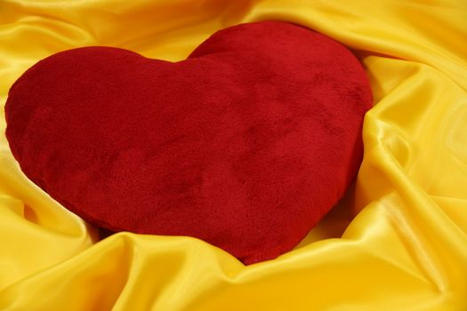 heart-shaped pillow on a yellow background