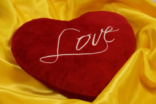 heart-shaped pillow on a yellow background