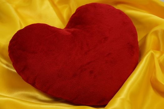 heart-shaped pillow on a yellow background