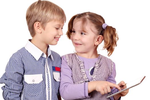 happy little girl and boy play with tablet pc