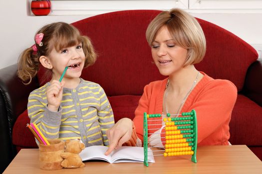 Mom helps daughter to solve homework