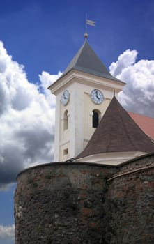 Tower of old castle on blue clouds.