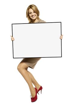 Attractive Young Woman Holding Up a Blank Sign. Studio shot of woman isolated on white background.