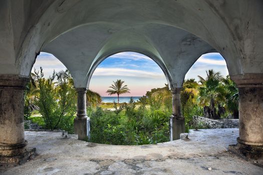 A beautiful view of the ocean from inside an old abandoned mansion.