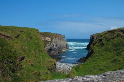 Small bay and grassy cliffs in Ireland
