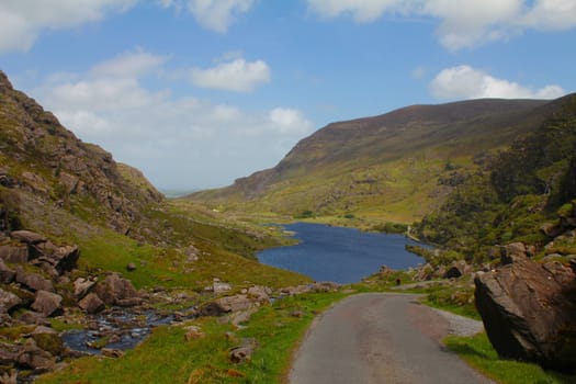 Winding road through the picturesque valley of Gap of Dunloe, Ireland 
