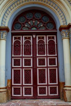 Decorated door of a church in Cuenca, Ecuador
