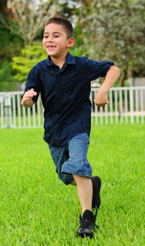young boy getting exercise and smiling a toothless grin