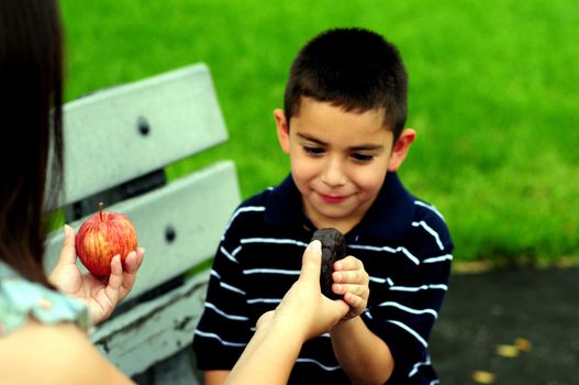 Young boy choosing junk food over healthy food