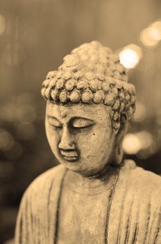 Buddha in meditation with profile shot in sepia