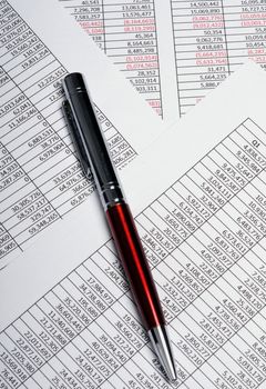 Business analysis spreadsheets showing sales results with pen