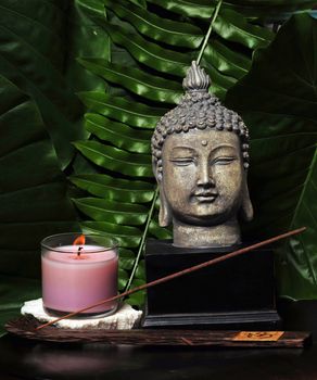 Items for a day spa with a Buddha statue and incense