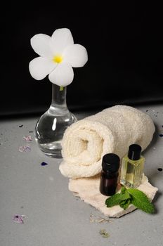 Essential oils and towels and frangipani flower