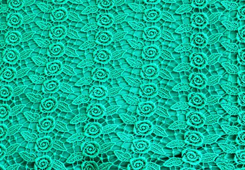 Detail of green lace pattern fabric 