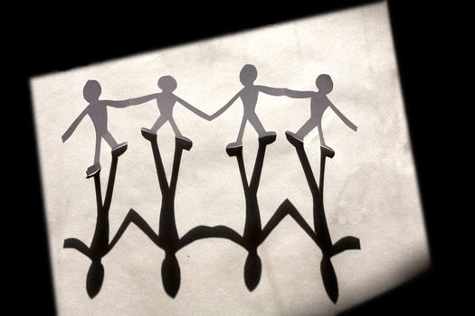 small rudimentary figures of man in paper