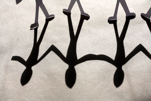 small rudimentary figures of man in paper