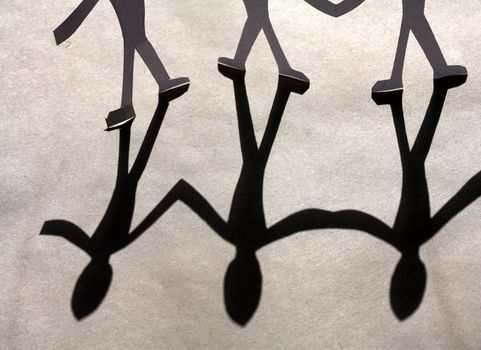 small rudimentary figures of man in paper