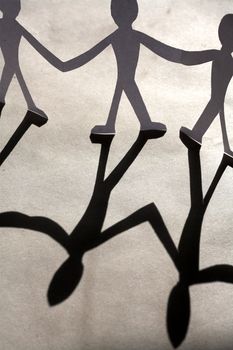small rudimentary figures of man in paper