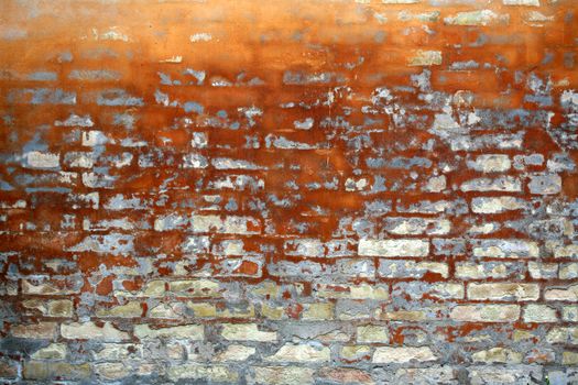 old wall of a house partly  in brick in orange colour
