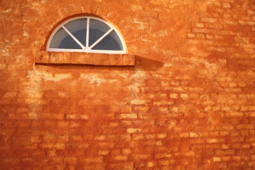 wall of a house partly  in brick with yellow surface

