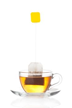 Cup of tea with tea bag (blank label) inside isolated on white background