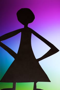 woman silhouette cut in small rudimentary figures  in paper , shot with colorfull background