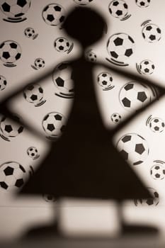 woman silhouette cut in small rudimentary figures  in paper , shot with colorfull background