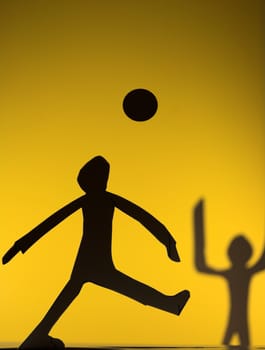 people silhouette cut in small rudimentary figures  in paper , shot with colorfull background