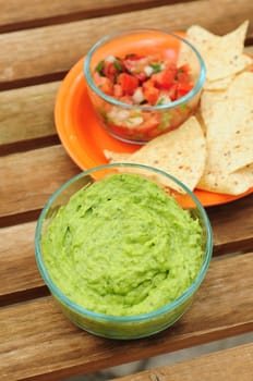 Guacamole dip with chips and salsa for a snack