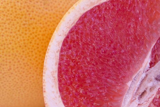 Fresh red grapefruit slice closeup, fruit background
