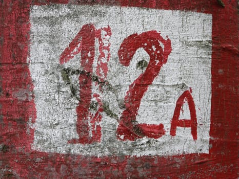 Number 12 painted in red on a wall